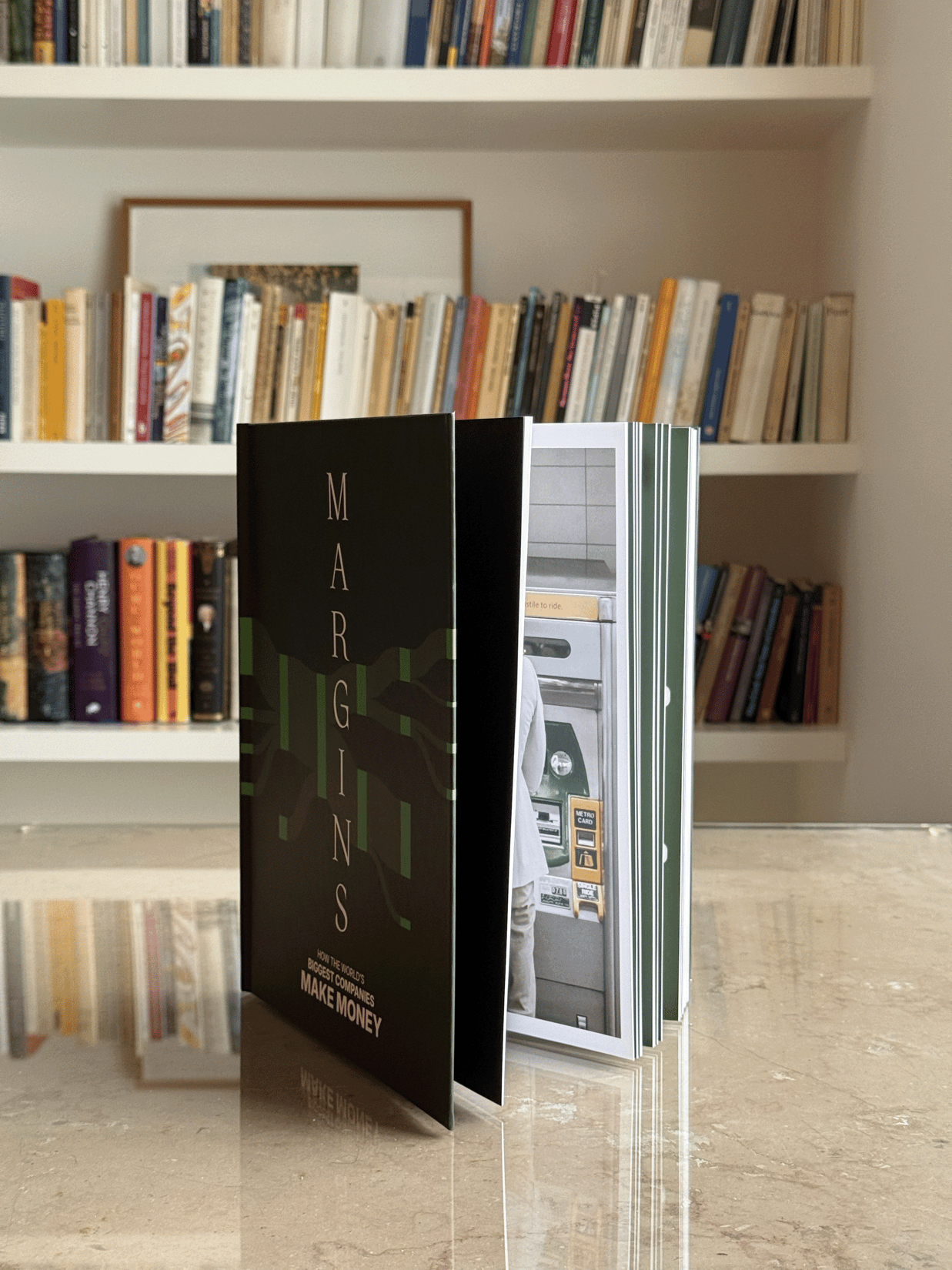 Photo of standing book with bookshelf in background, full screen view